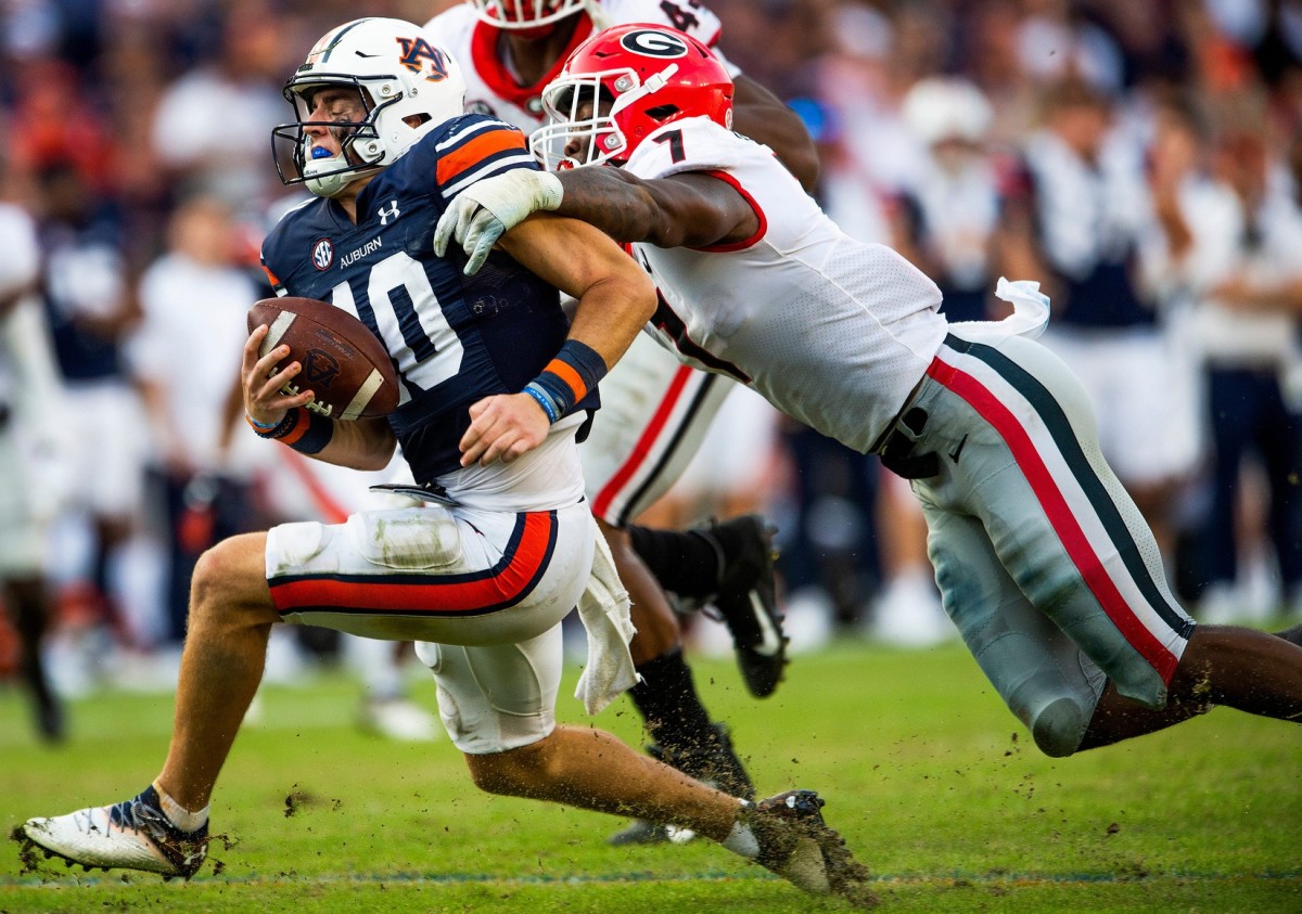 Auburn Tigers quarterback Bo Nix (10) is sacked by Georgia Bulldogs linebacker Quay Walker (7). Jake Crandall / USA TODAY NETWORK